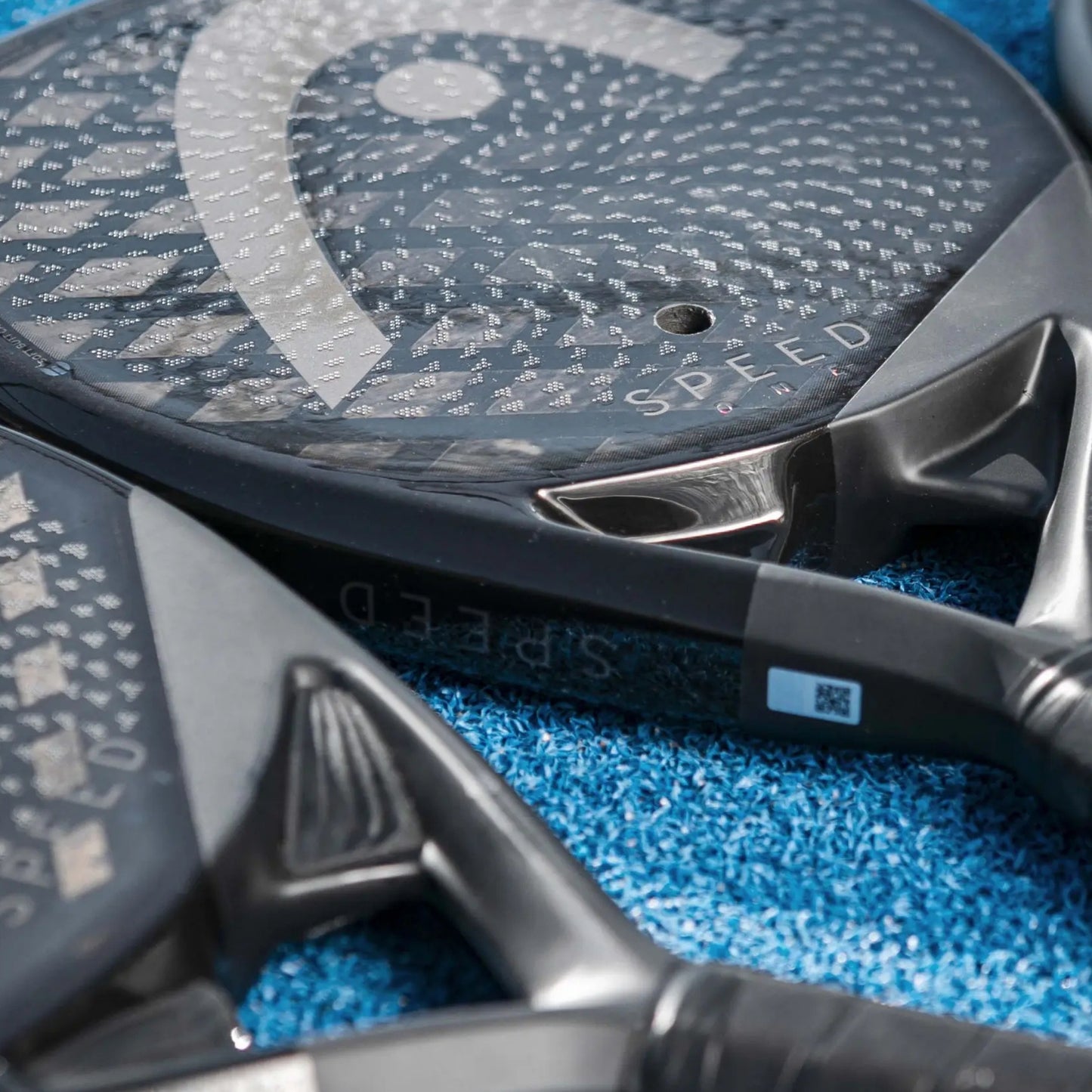 Close-up of a Head padel racket with the logo at the bottom on a white background