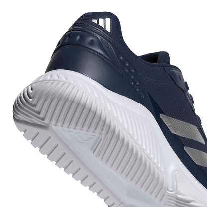 Close-up of a shoe blue padel shoe with a white tread pattern on a white background
