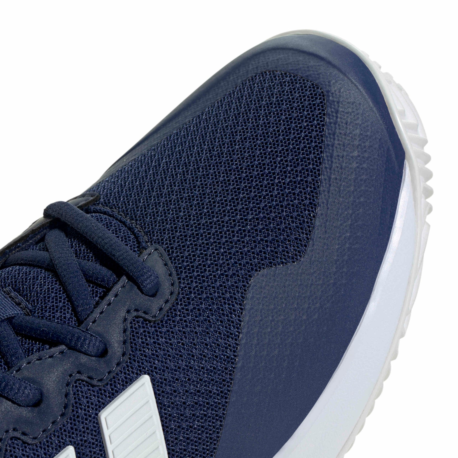 Navy blue tennis shoe with white sole on a white background