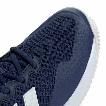 Navy blue tennis shoe with white sole on a white background