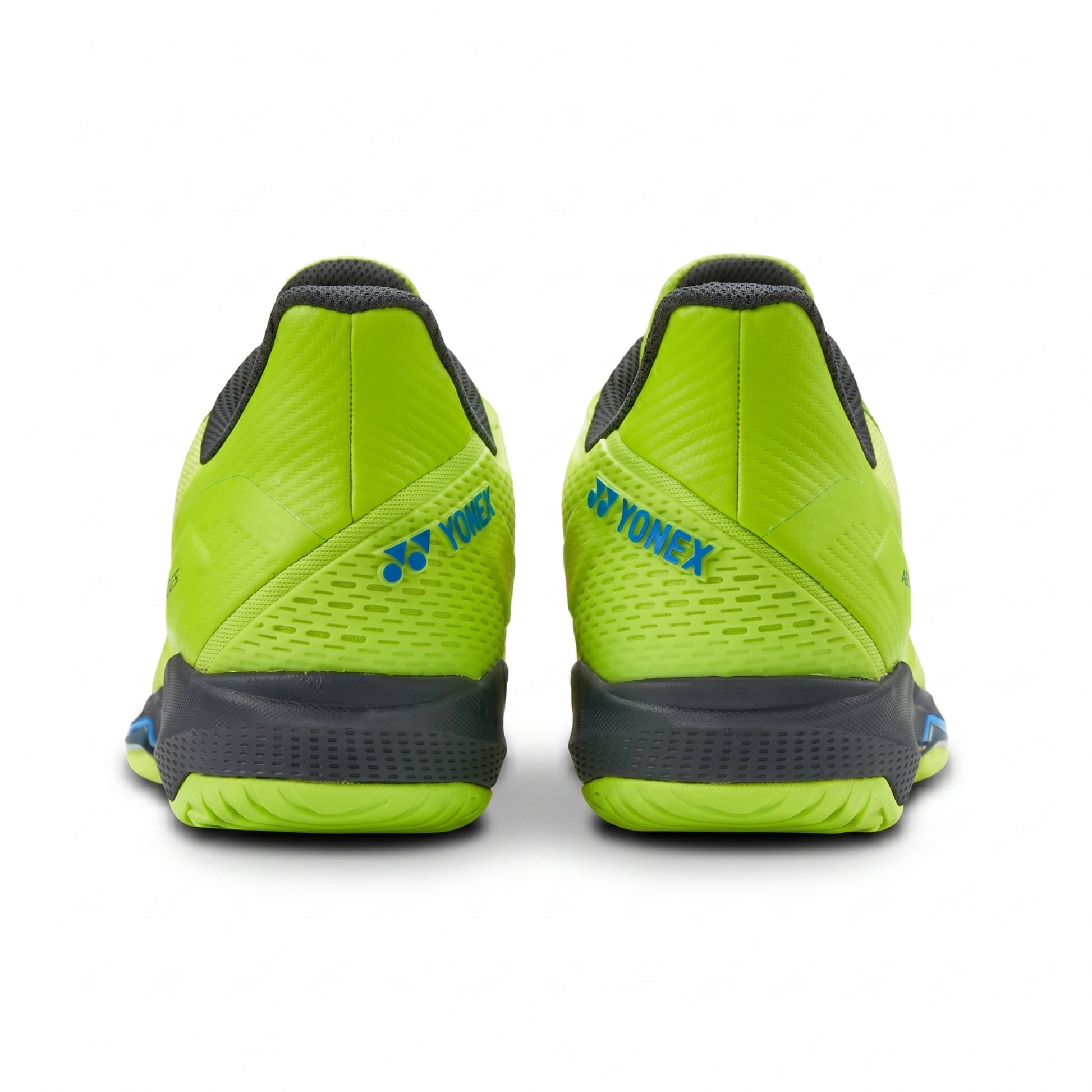 Green athletic shoes with Yonex branding on a white background