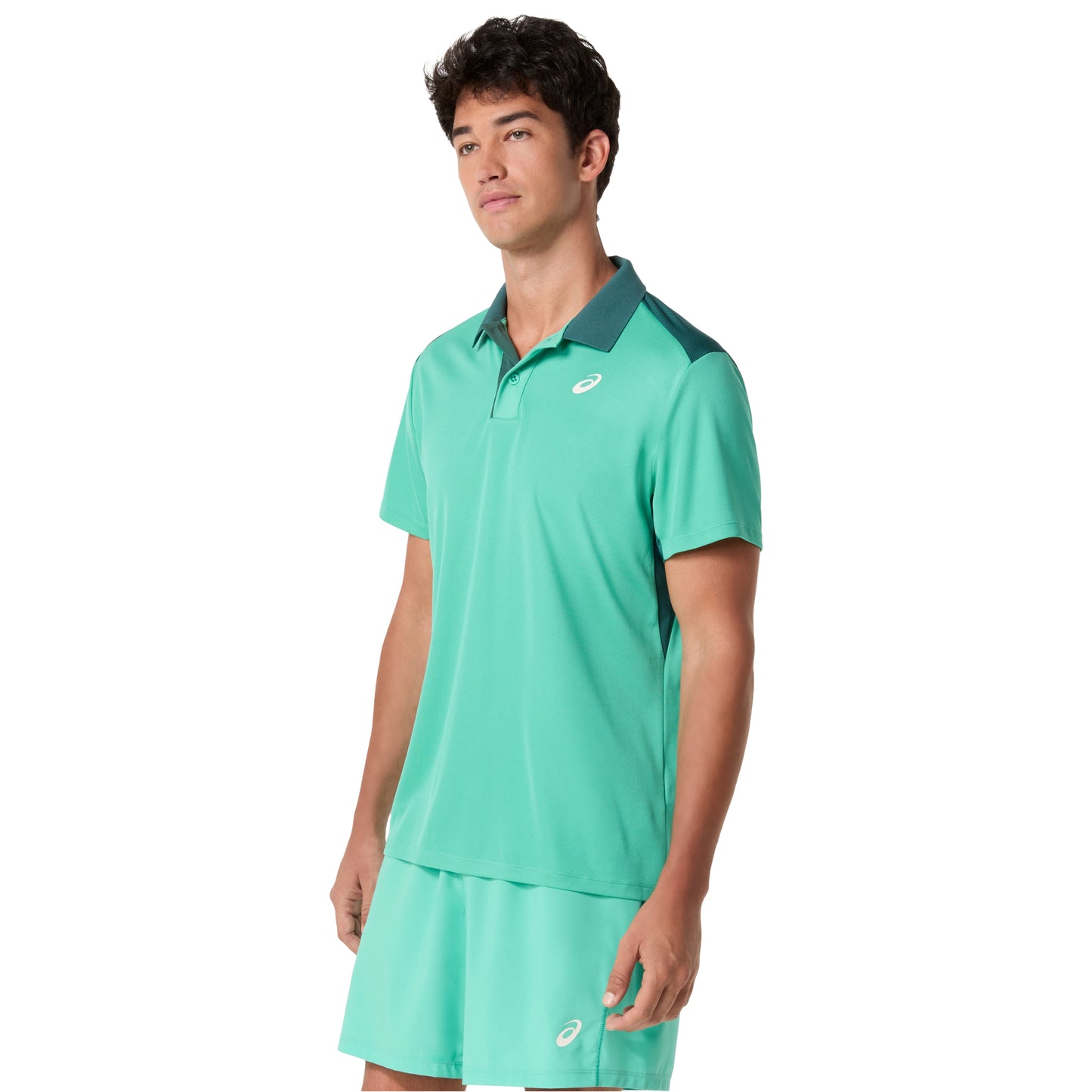 Man wearing a green athletic outfit with a visible brand logo on a white background