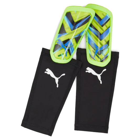 Black leggings with Puma logo and green and blue shin guards on a white background