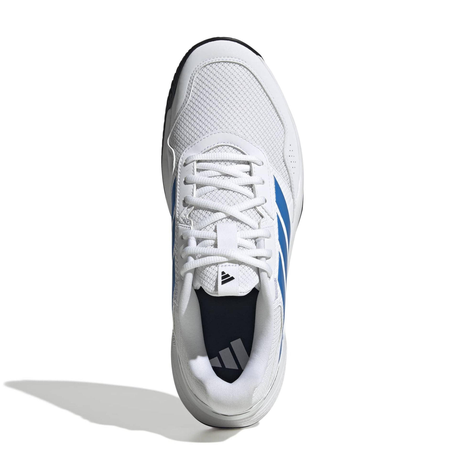 White adidas tennis shoe with blue a blue logo with a black sole on a white background.