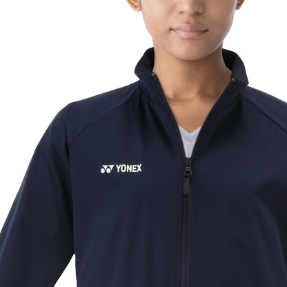 Person wearing a navy blue jacket with Yonex logo on a white background