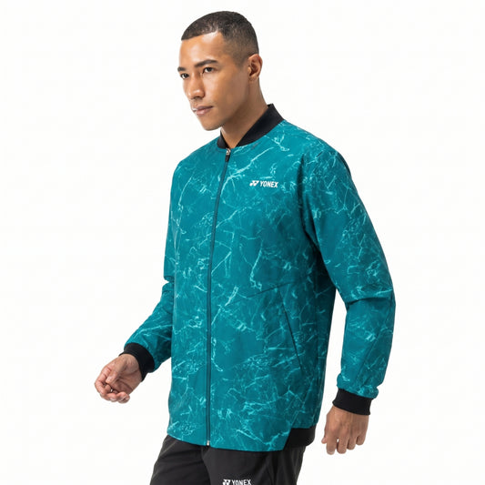 Man wearing a teal Yonex jacket on a white background