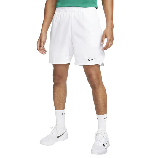 Person wearing white Nike shorts and shoes on a white background
