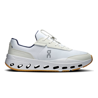 A white On tennis shoe with navy blue accents, a chunky white midsole with black cutouts, and a gum outsole, shown from a side profile on a white background.