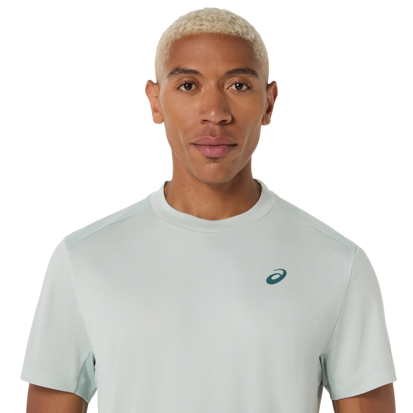 Man wearing a cold moss t-shirt with a small logo on a white background