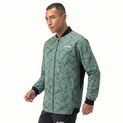 Man wearing a green patterned jacket with Yonex logo on a white background