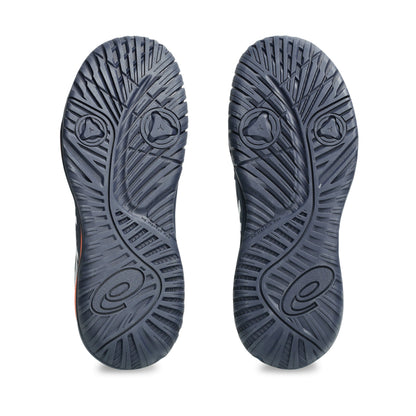 Close-up of a pair of navy tennis shoes with tread pattern on a white background