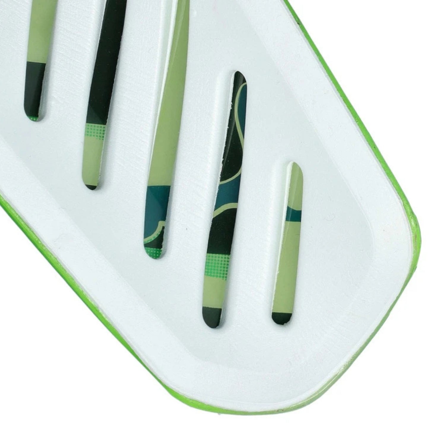 Close-up of back side of the shin guard green and black patterns on a white background