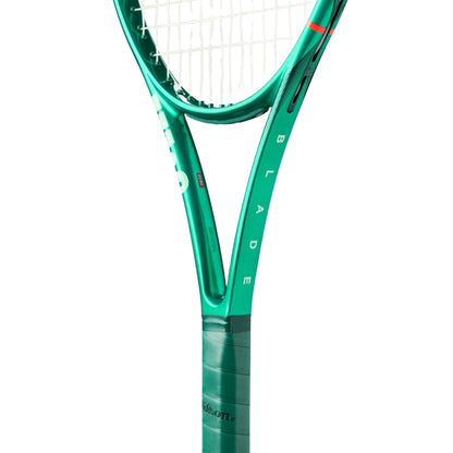 Close-up of a green tennis racket with 'Wilson' branding on a white background