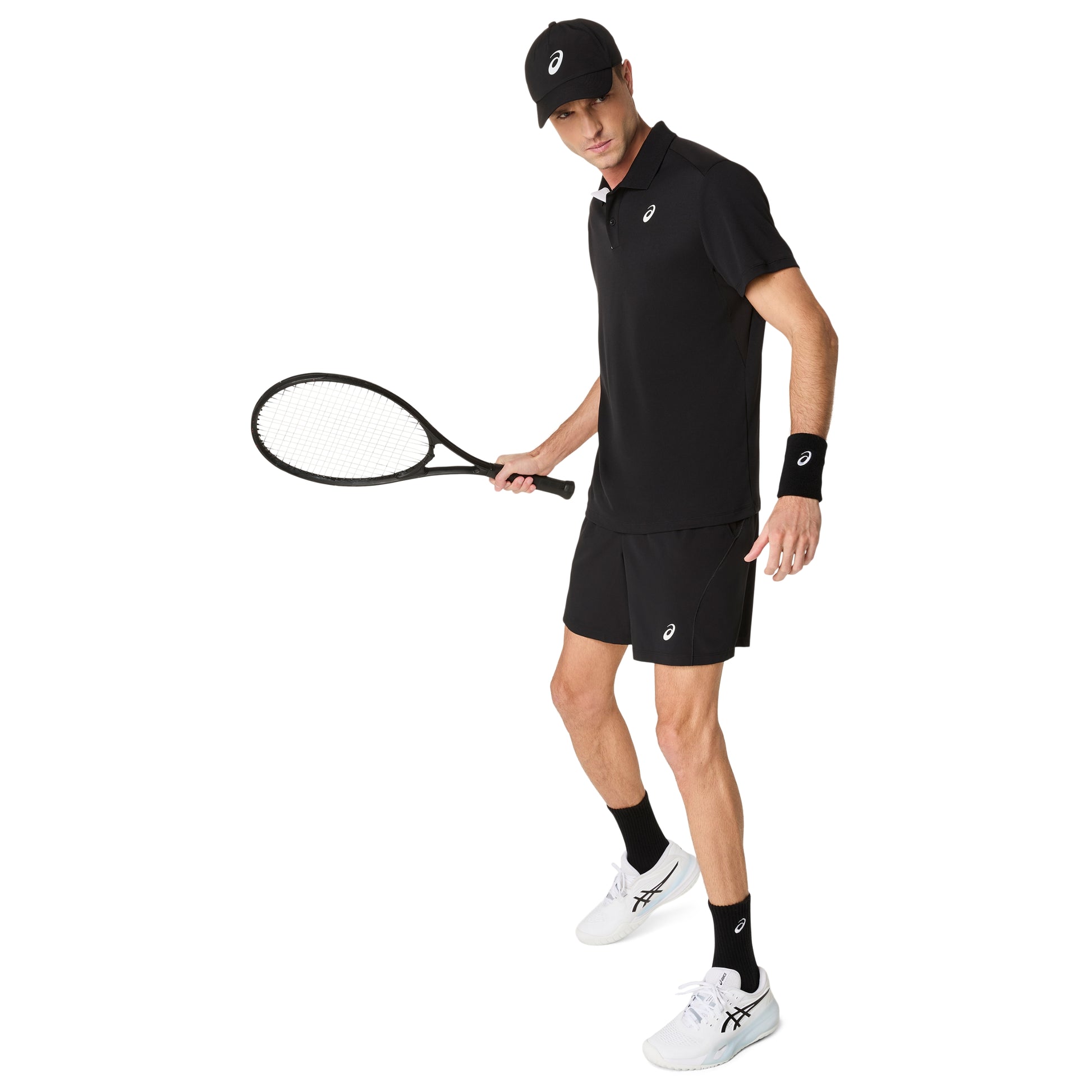 Man in black tennis outfit holding a racket on a white background