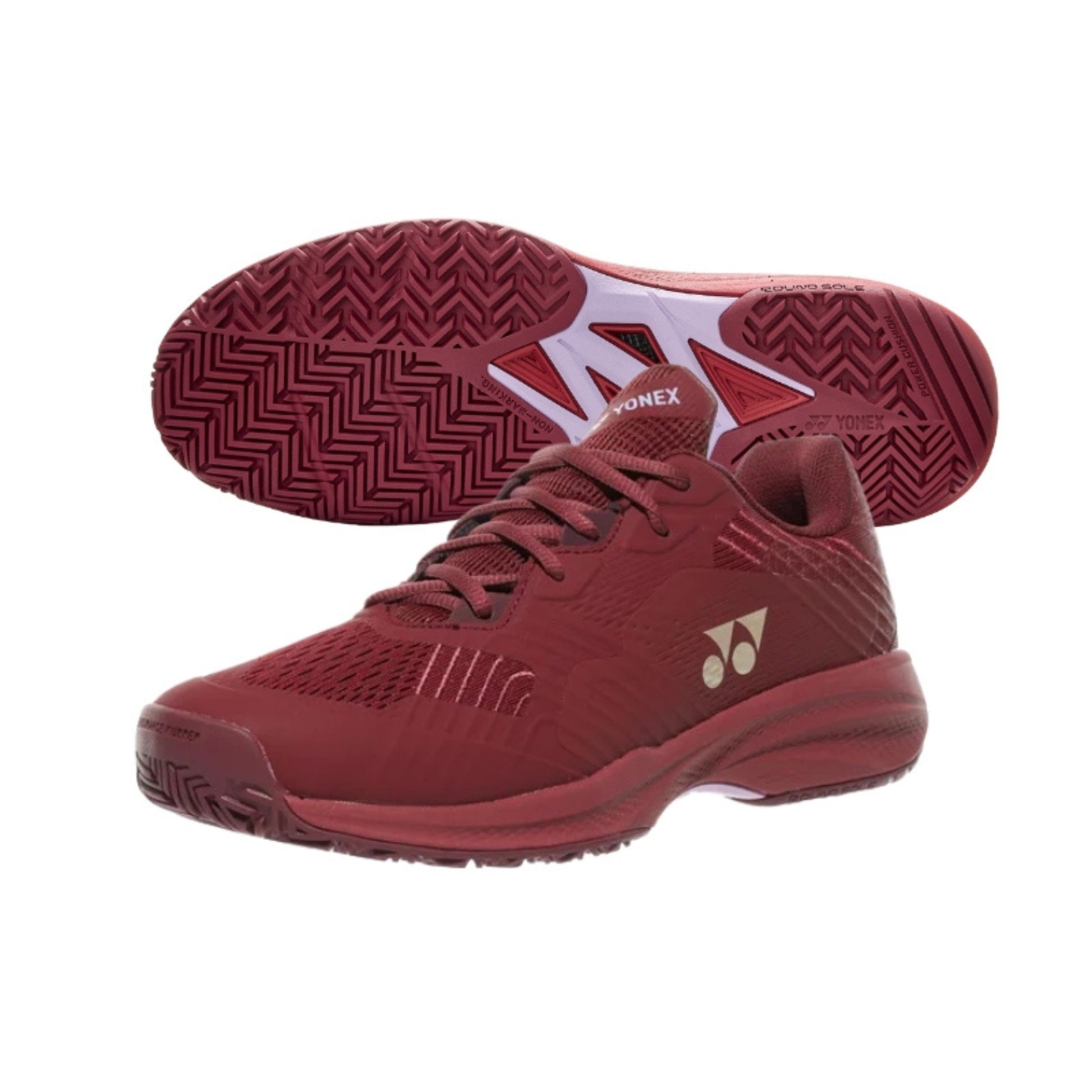 Red Yonex tennis shoes with a brand logo on a white background