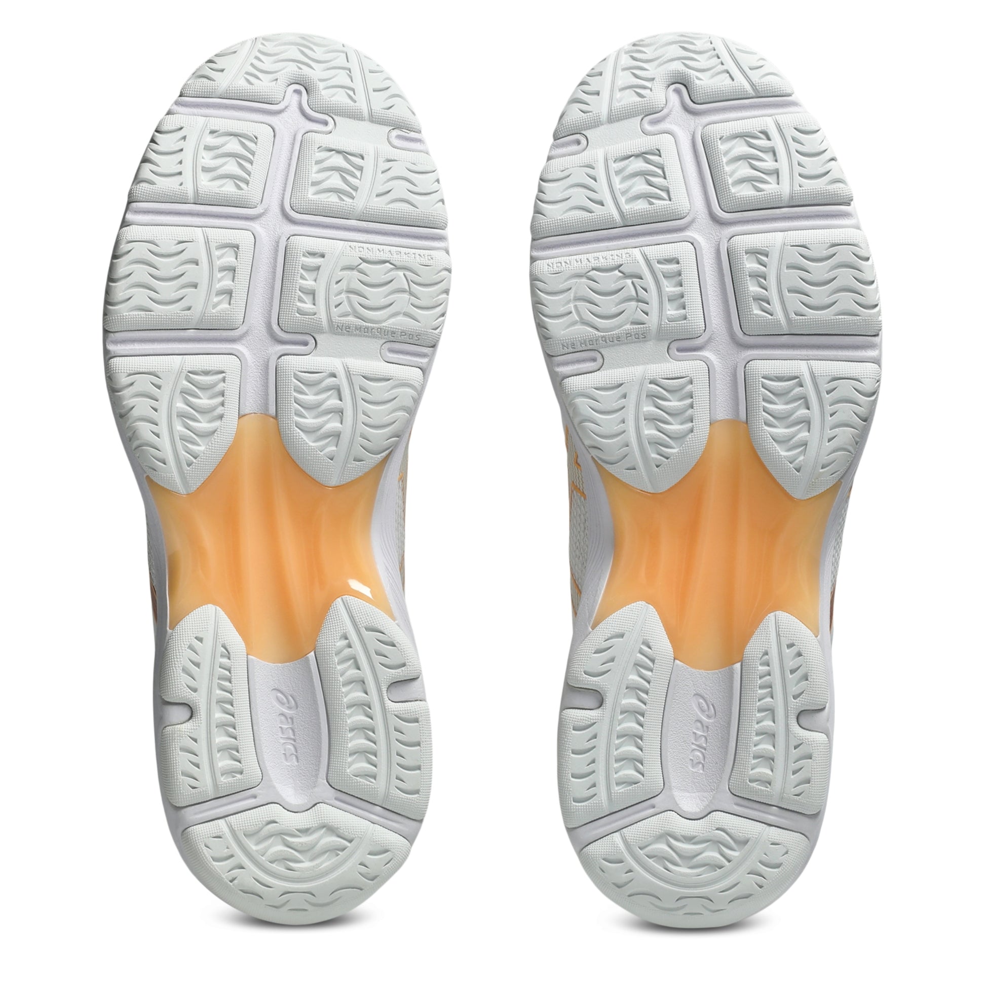 A pair of netball shoes shown from the sole view, featuring a white textured outsole with a translucent orange midsole section.