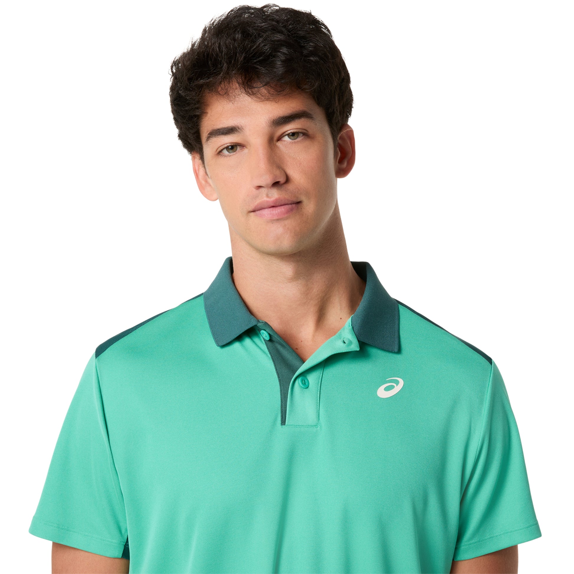 Man wearing a green polo shirt with a brand logo on a white background