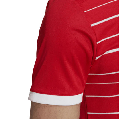 Red sports jersey with white stripes on a white background