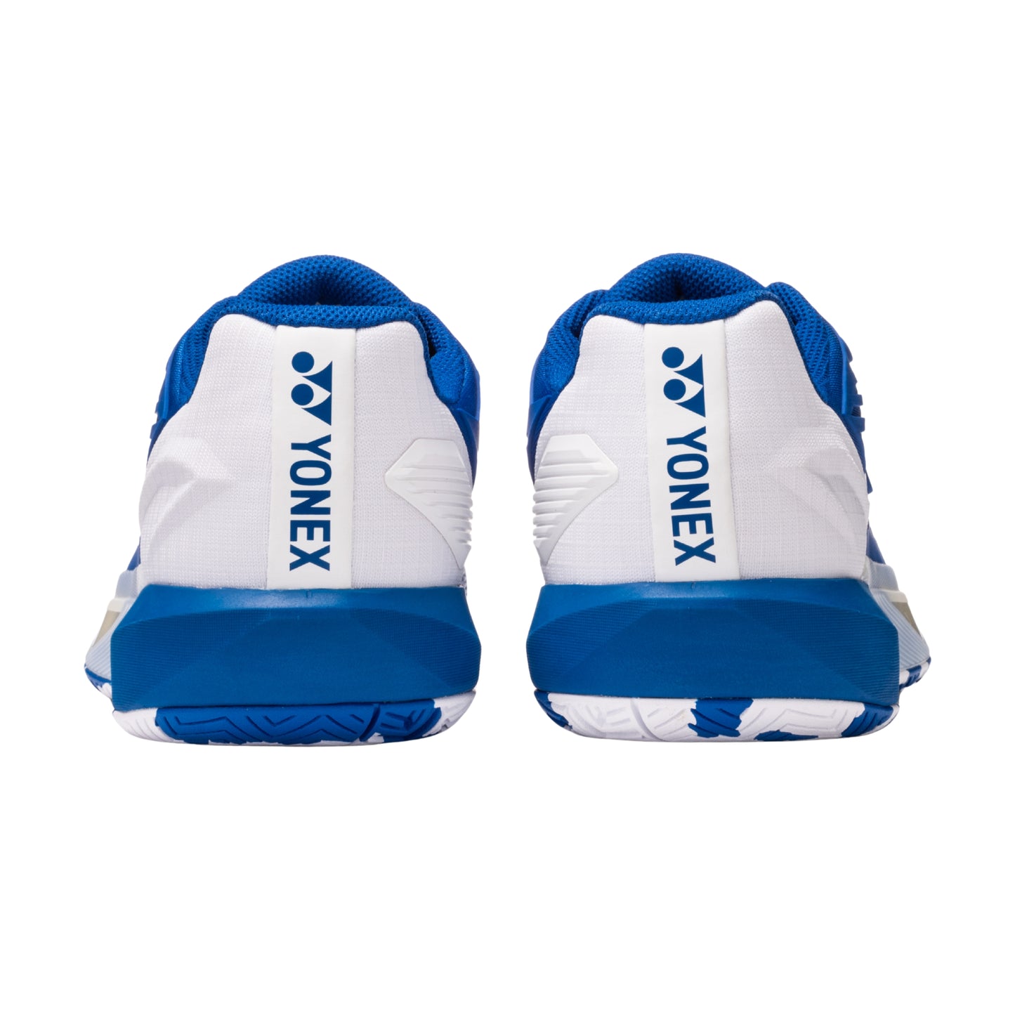 Blue and white Yonex tennis shoes on a white background