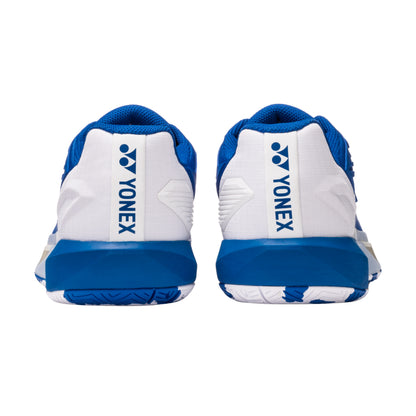 Blue and white Yonex tennis shoes on a white background