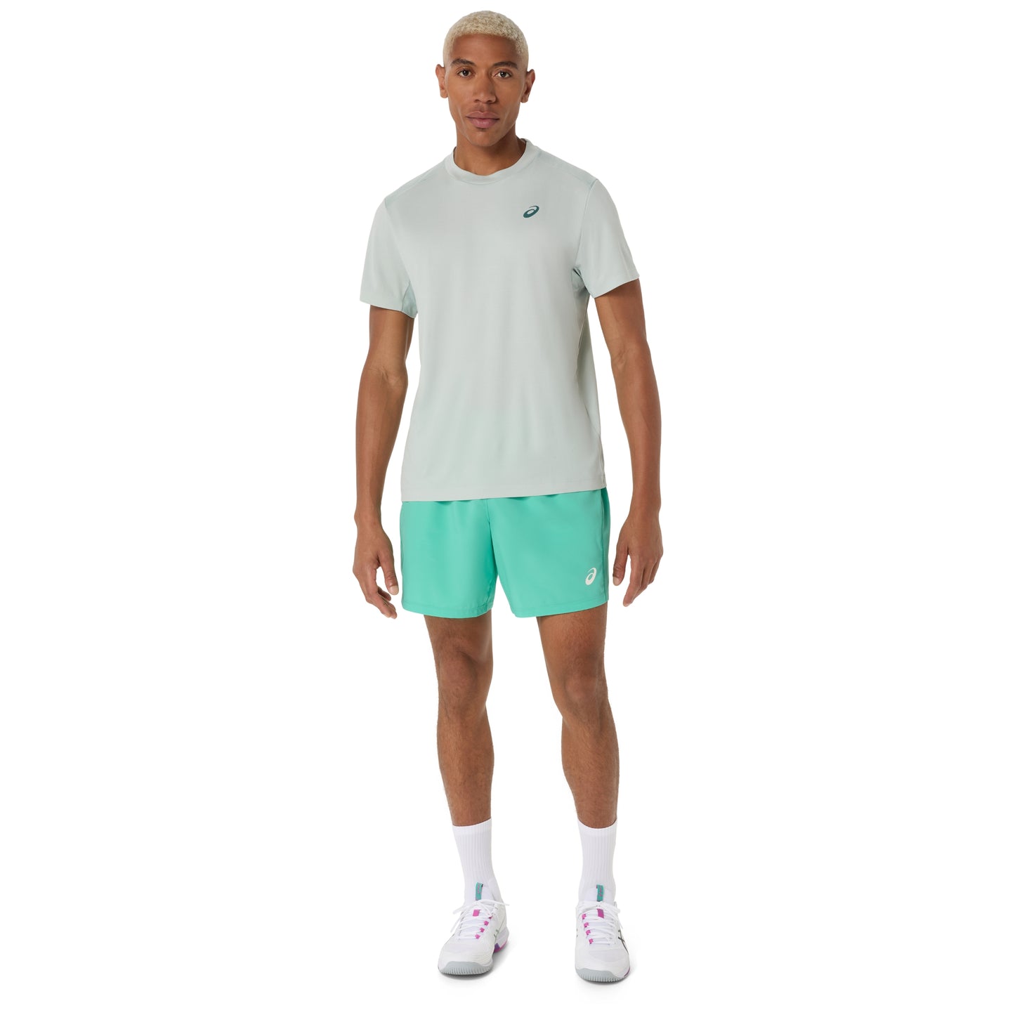 Man wearing a cold moss t-shirt and turquoise shorts with a brand logo on a white background