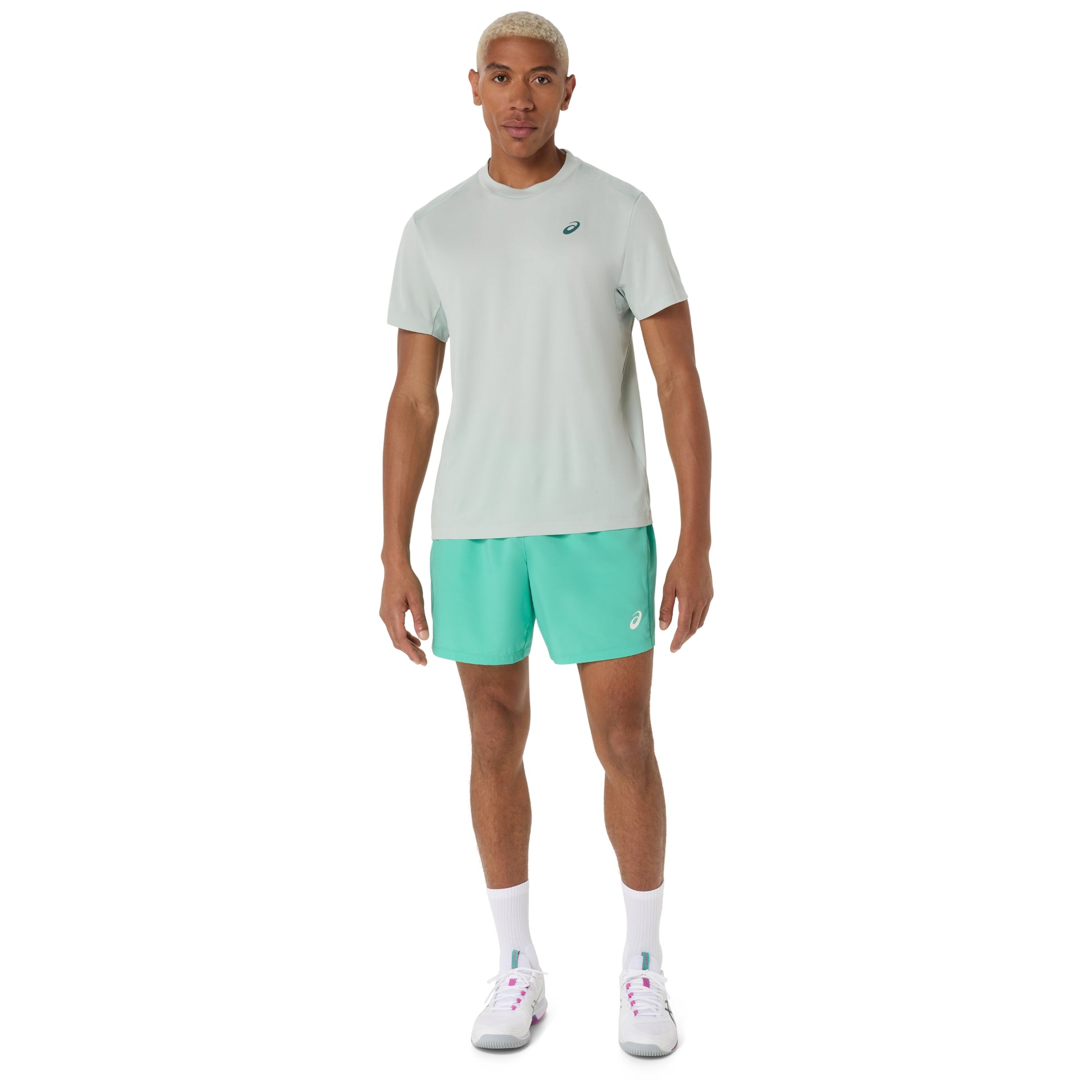 Man wearing a cold moss t-shirt and turquoise shorts with a brand logo on a white background