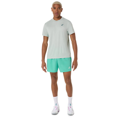 Man wearing a cold moss t-shirt and turquoise shorts with a brand logo on a white background