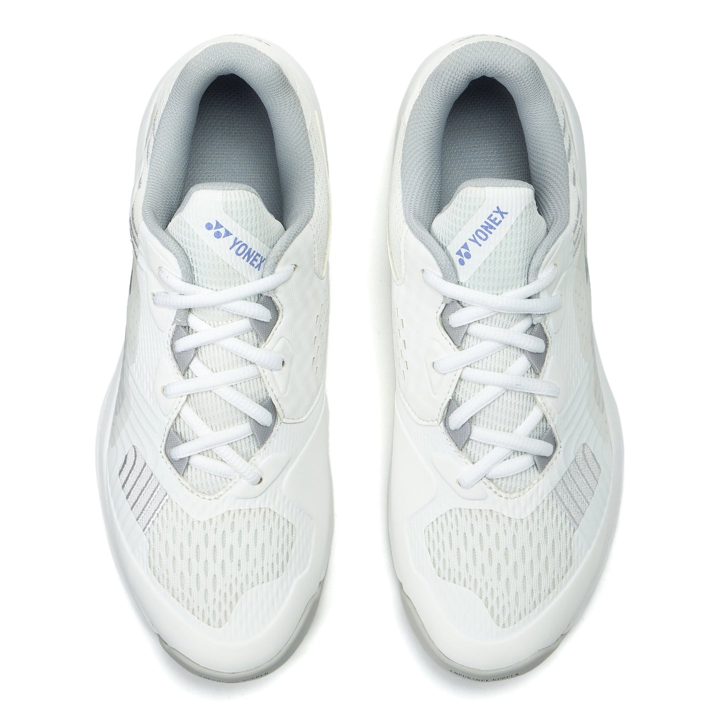 Pair of white Yonex tennis shoes on a white background