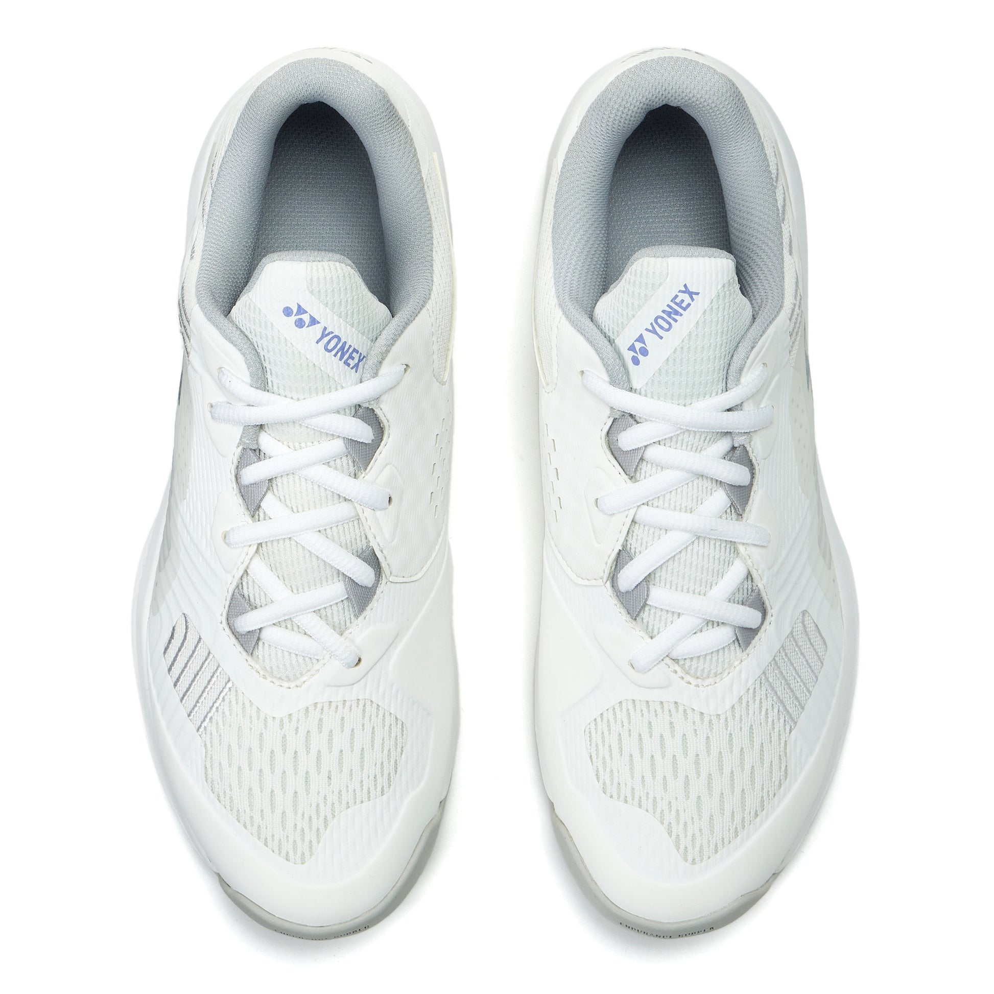 Pair of white Yonex tennis shoes on a white background
