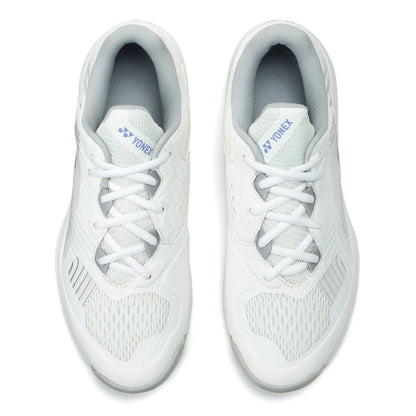 Pair of white Yonex tennis shoes on a white background