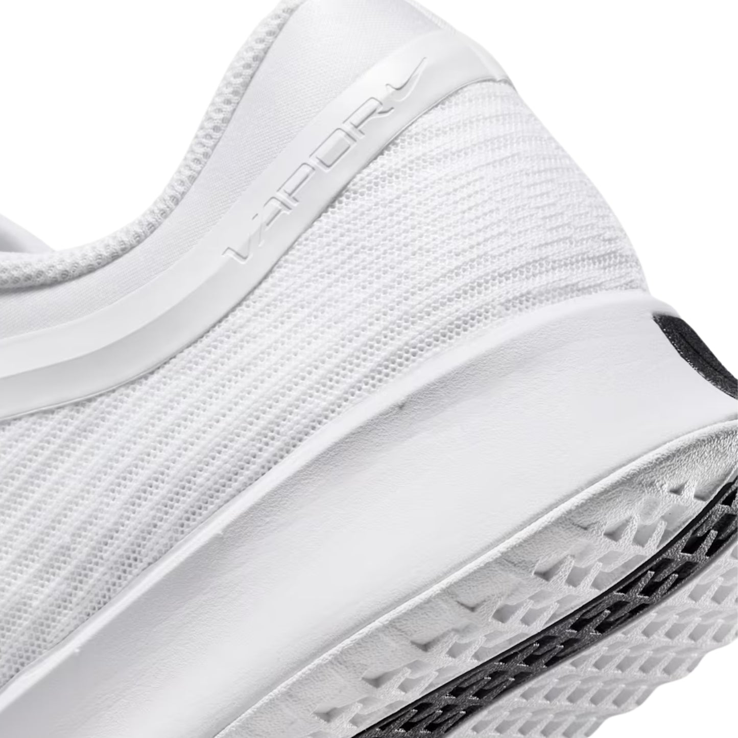 Close-up of a white tennis shoe with text on the side