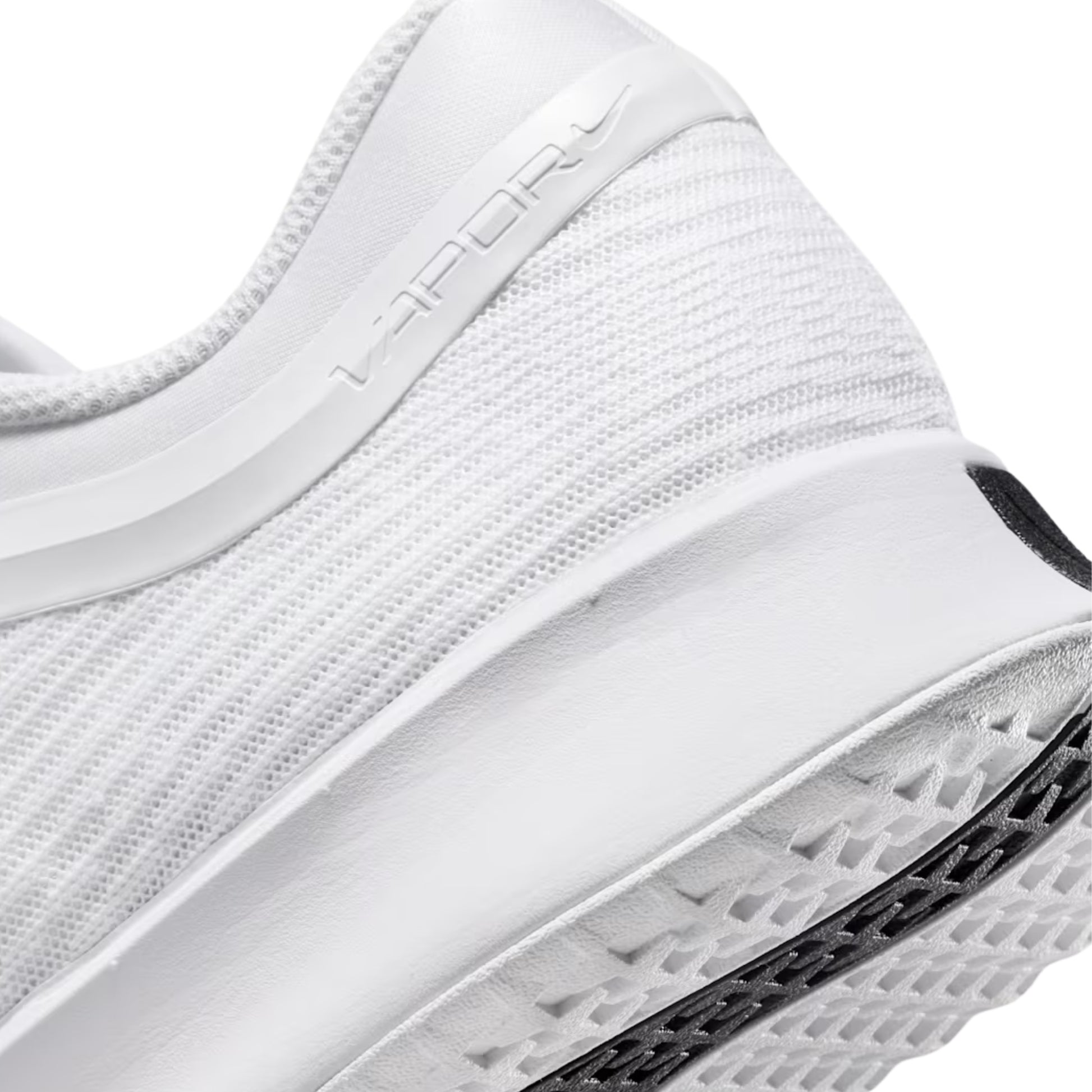 Close-up of a white tennis shoe with text on the side