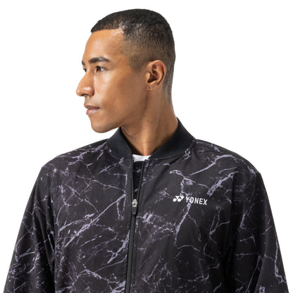 Man wearing a black and gray marbled jacket with Yonex logo on a white background