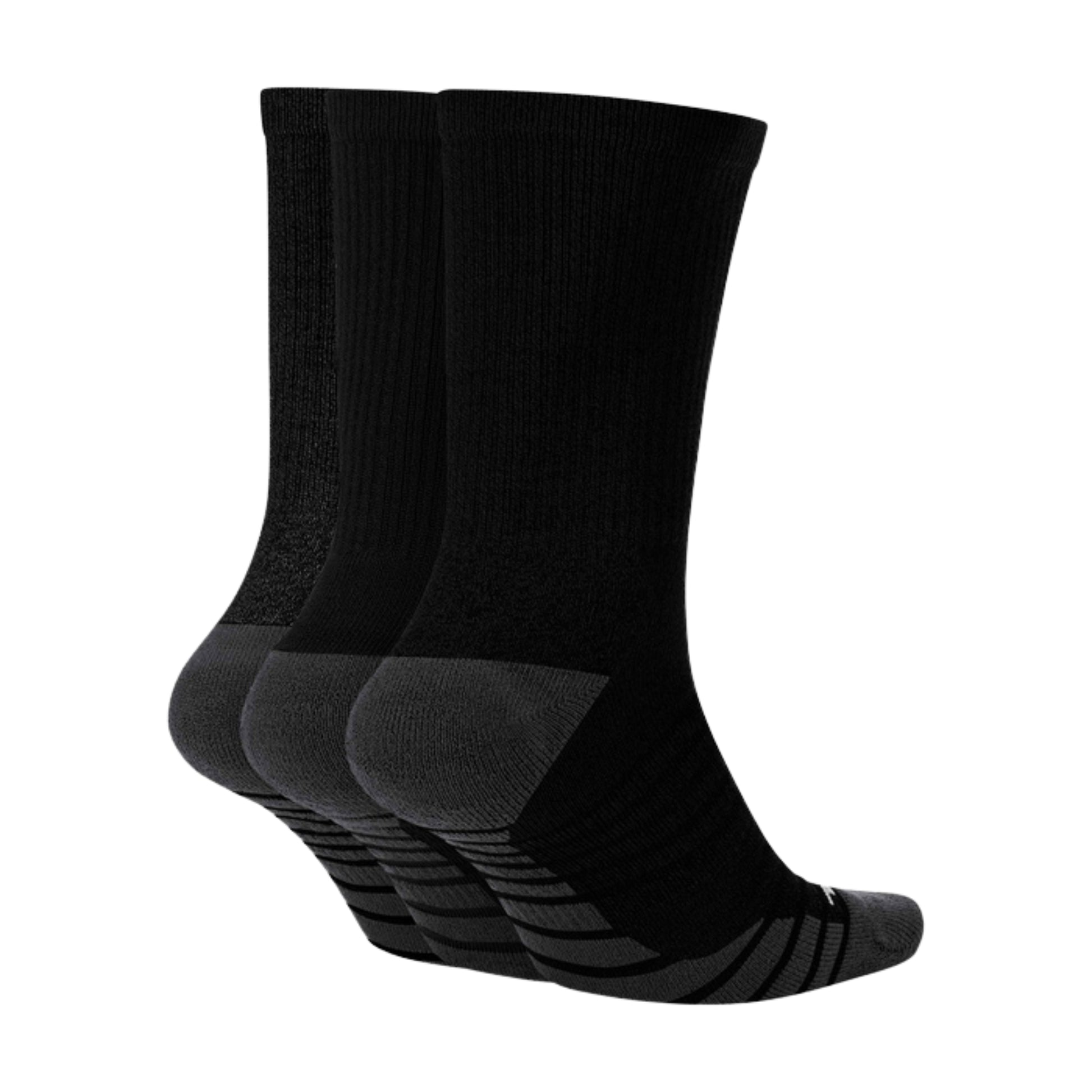 Three pairs of black socks on a white background