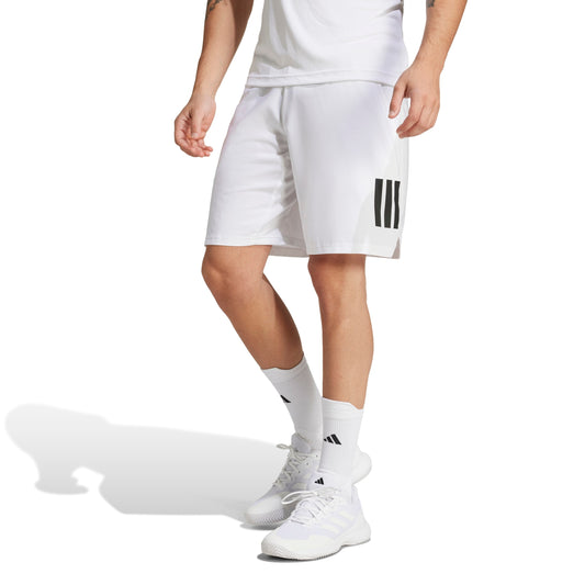 Person wearing white athletic adidas shorts with black stripes on a white background