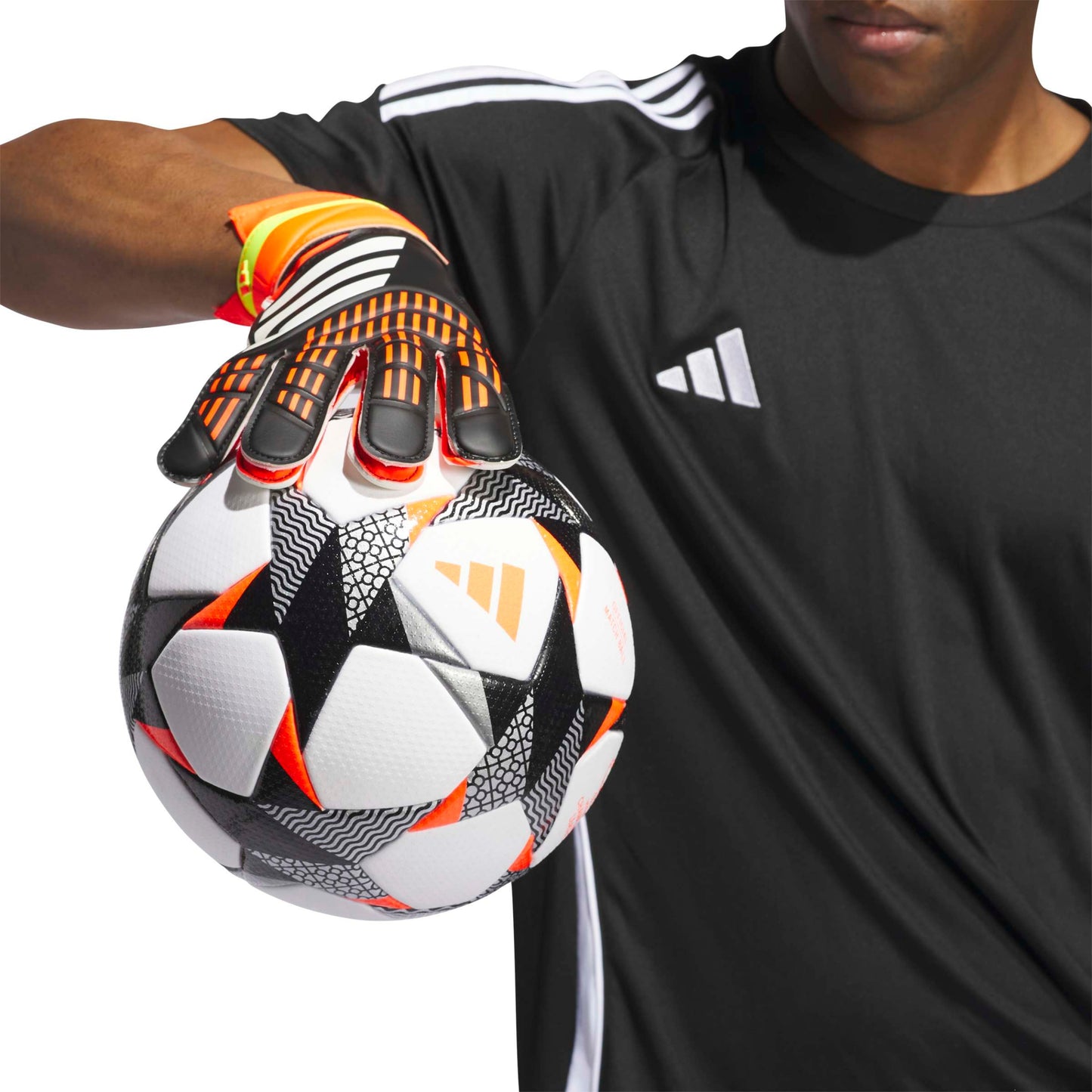 Person holding a soccer ball with a black and orange glove