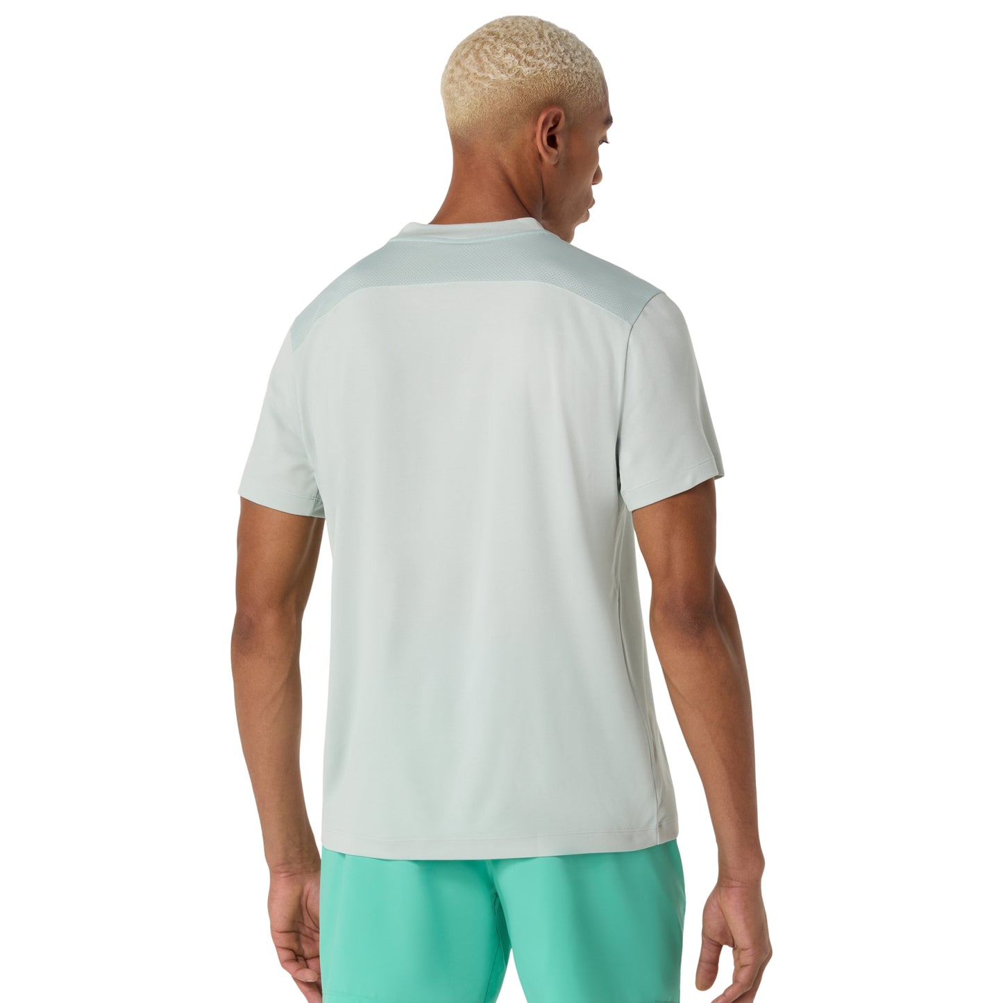Man wearing a cold moss t-shirt and teal shorts on a white background