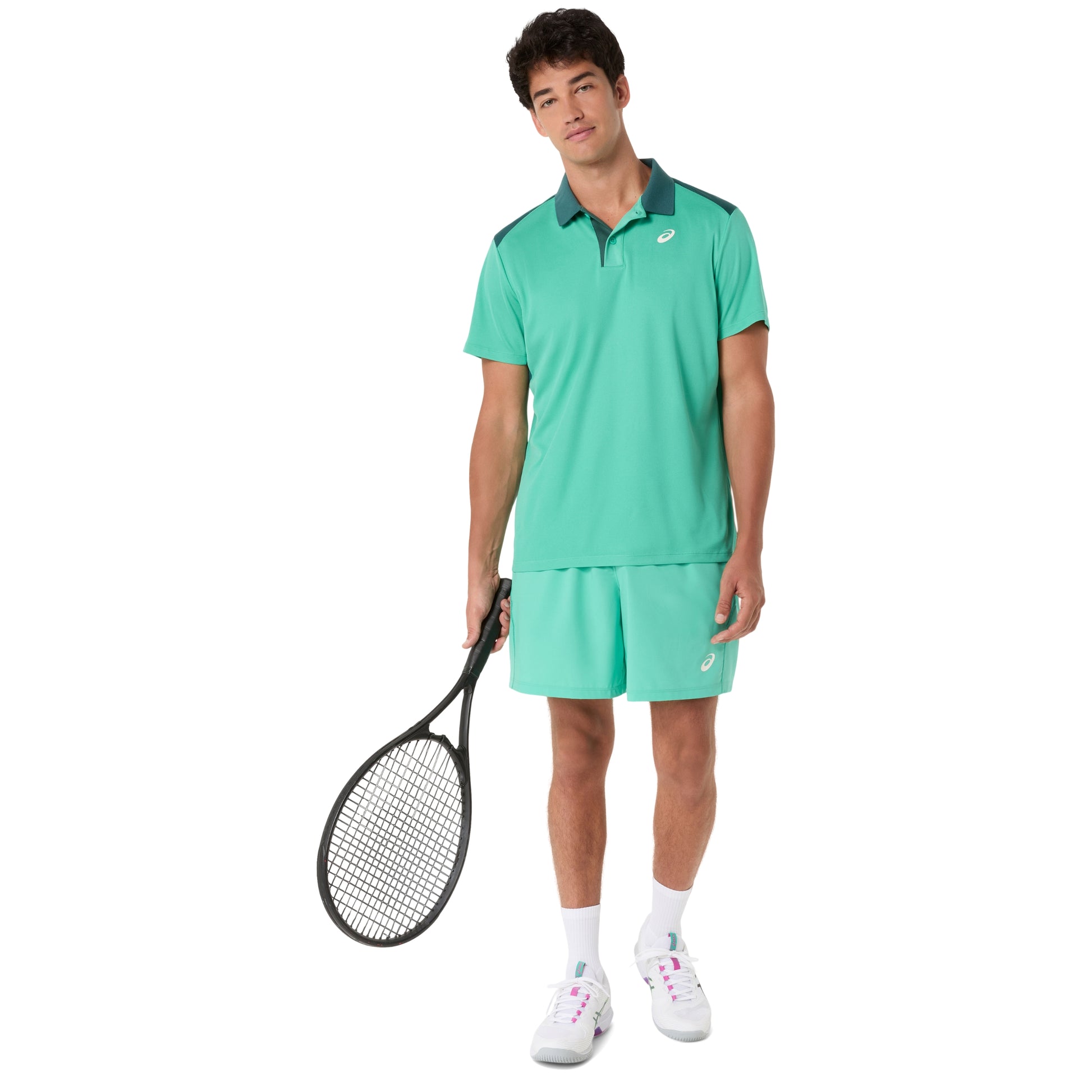 Man wearing a green tennis outfit holding a racket on a white background