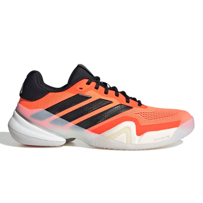 Orange and black Adidas tennis shoe on a white background