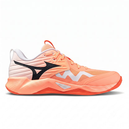 A single Mizuno squash shoe in a coral orange colorway, featuring a white and coral mesh upper, a black Mizuno wave logo on the side, and a thick sculpted coral midsole, shown against a plain white background.