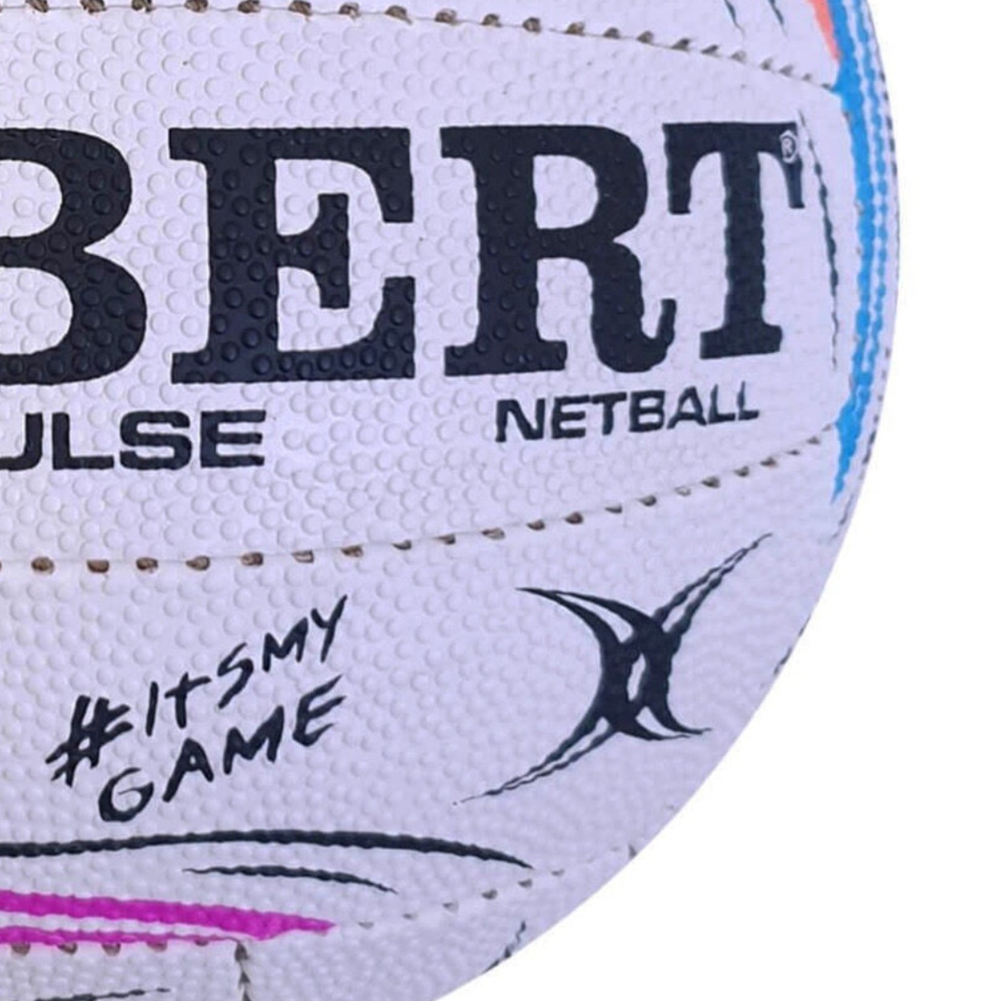 Close-up of a Gilbert Pulse netball with branding and text on the surface.