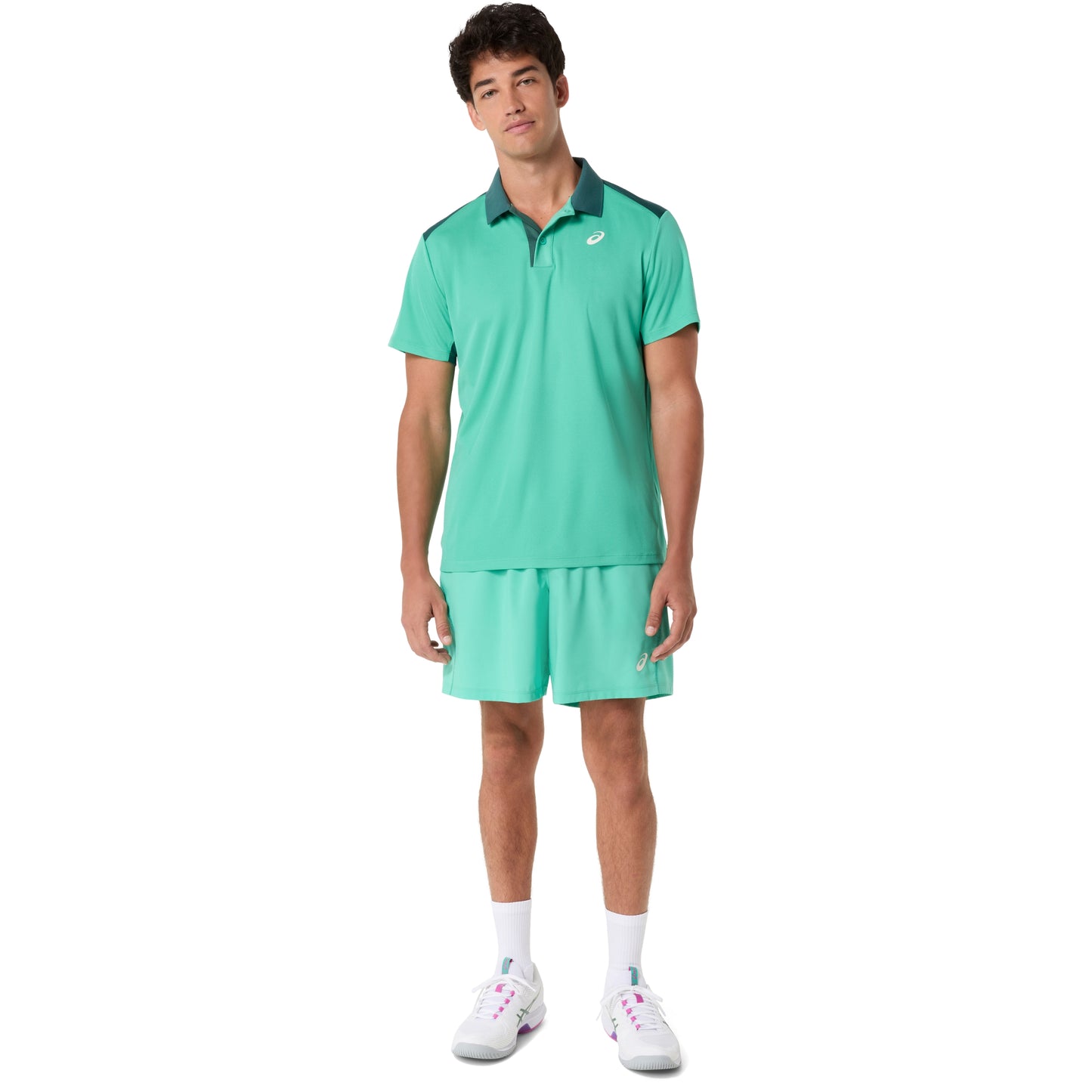 Man wearing a green tennis outfit on a white background