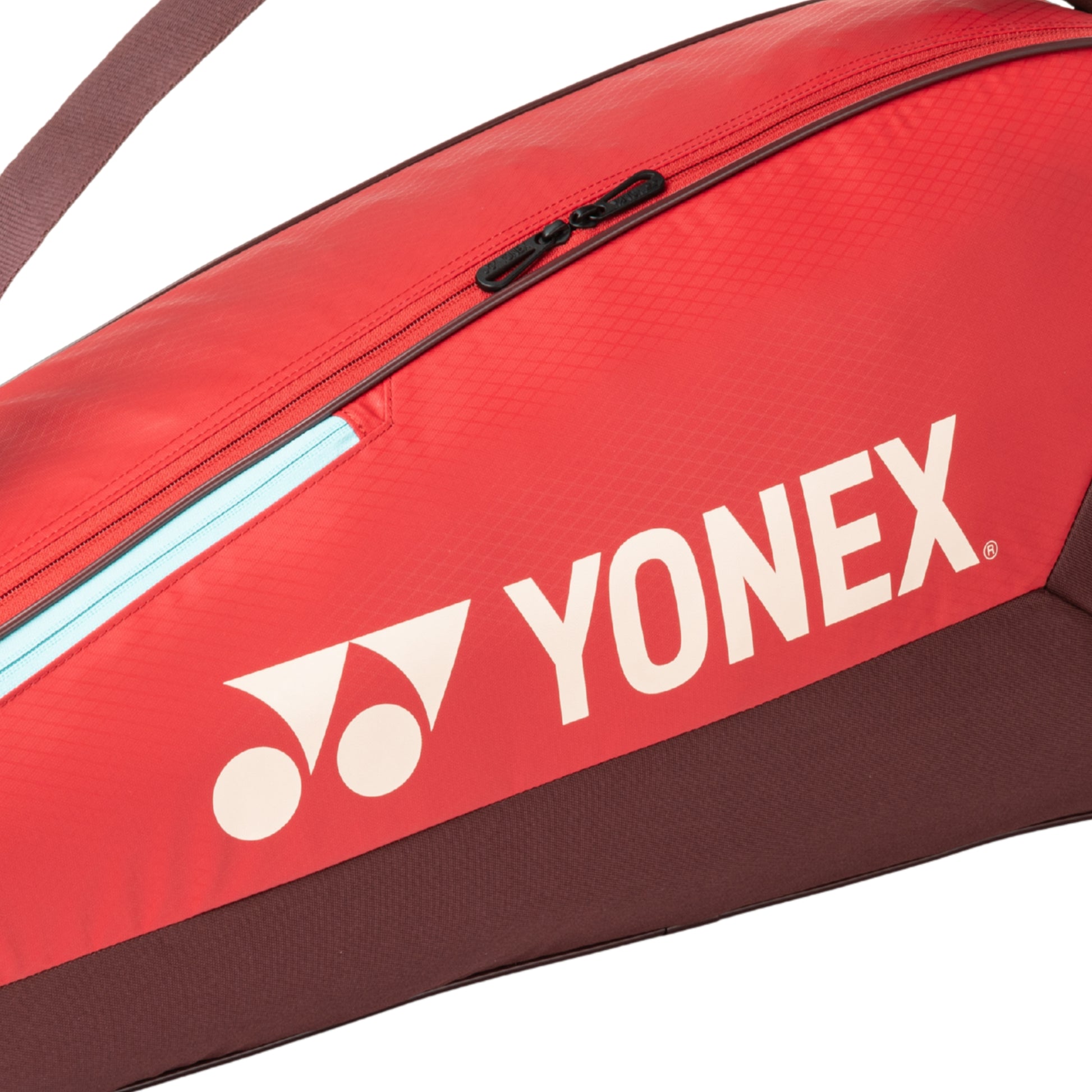 Red Yonex tennis bag with white logo on a white background