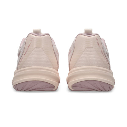 Pair of beige netball shoes with pink soles on a white background