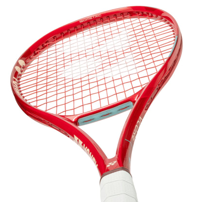 Red Yonex tennis racket with white strings on a white background