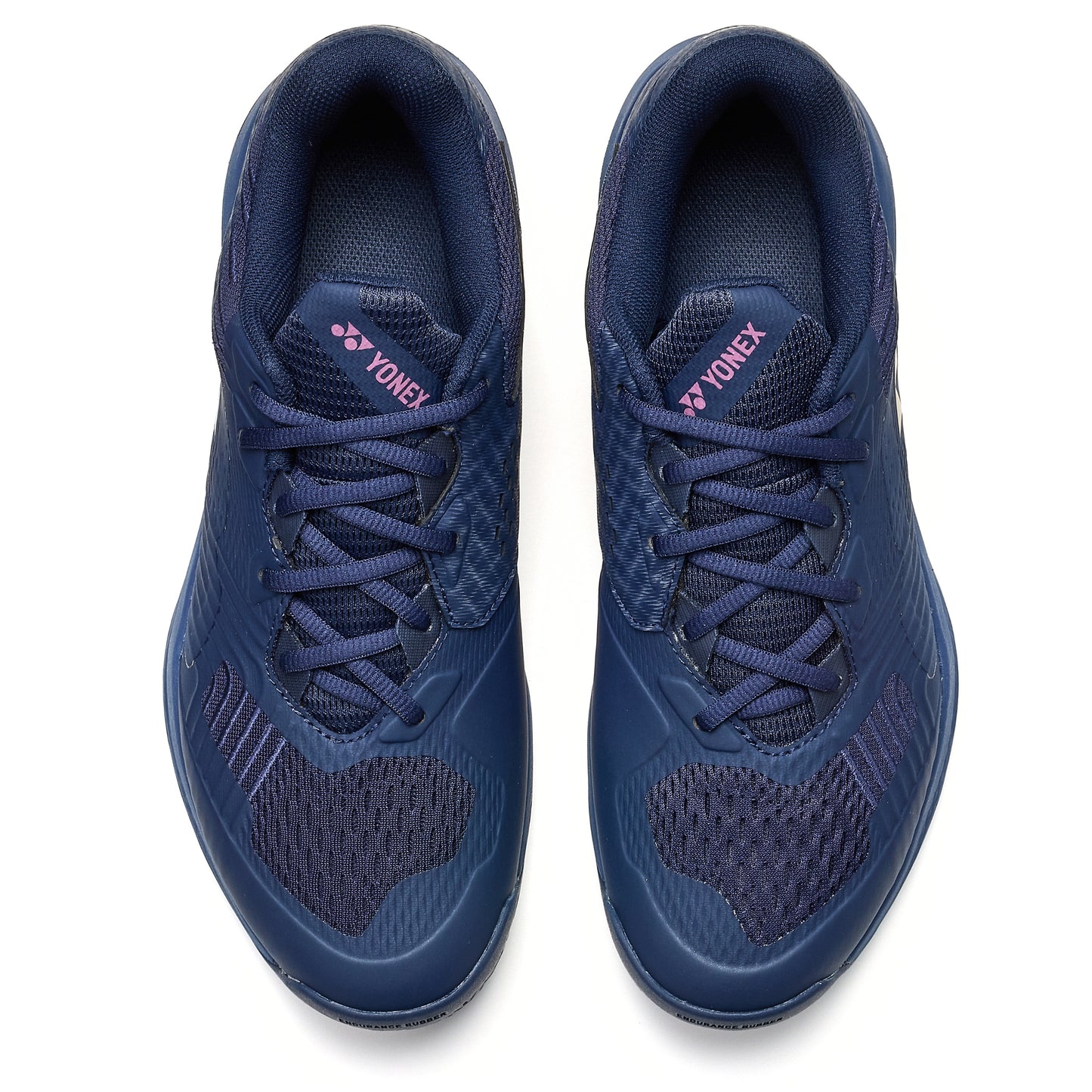 Pair of navy blue Yonex tennis shoes on a white background