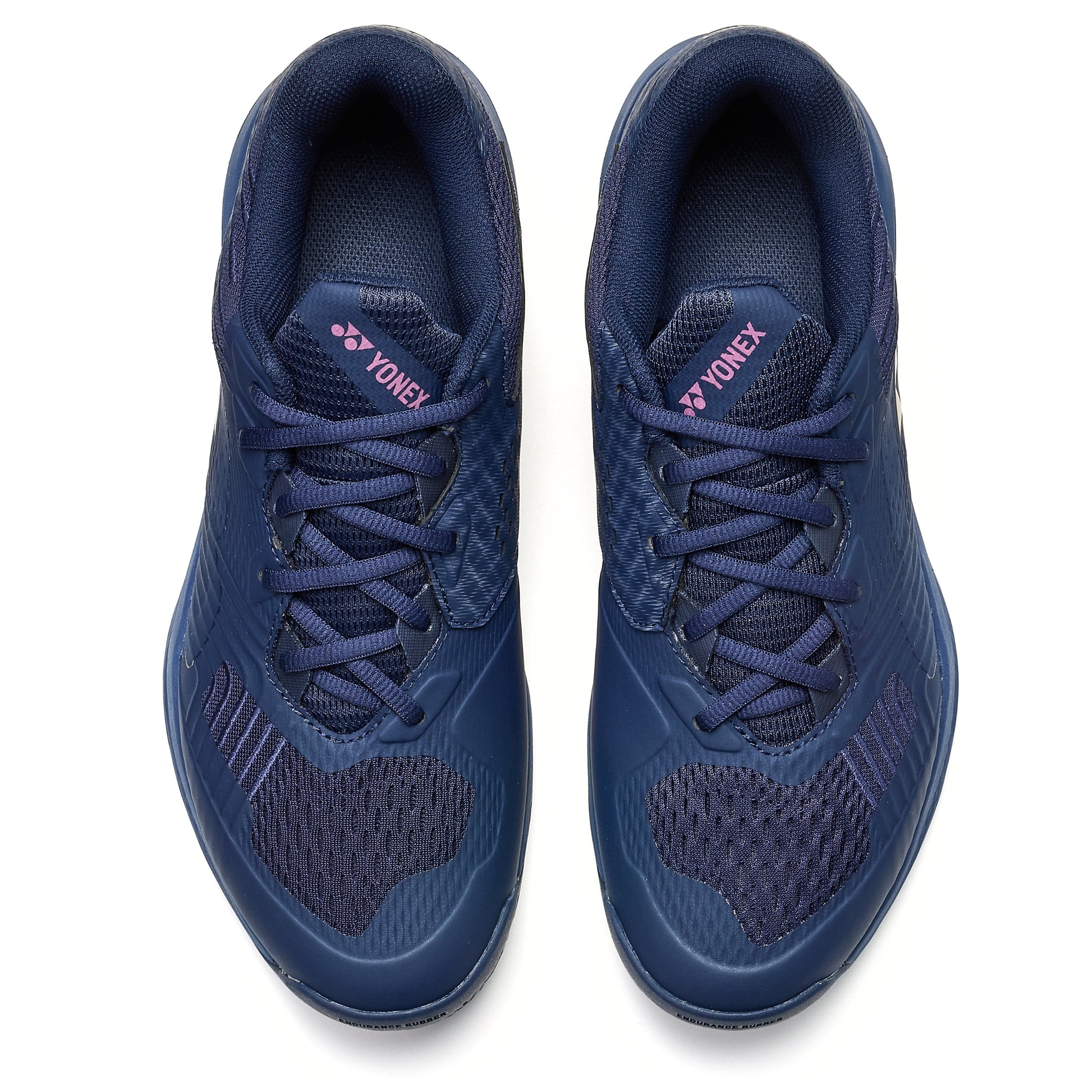 Pair of navy blue Yonex tennis shoes on a white background