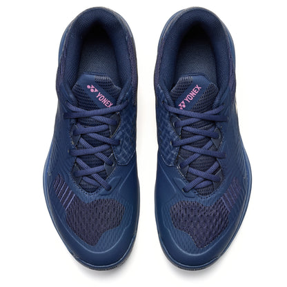 Pair of navy blue Yonex tennis shoes on a white background