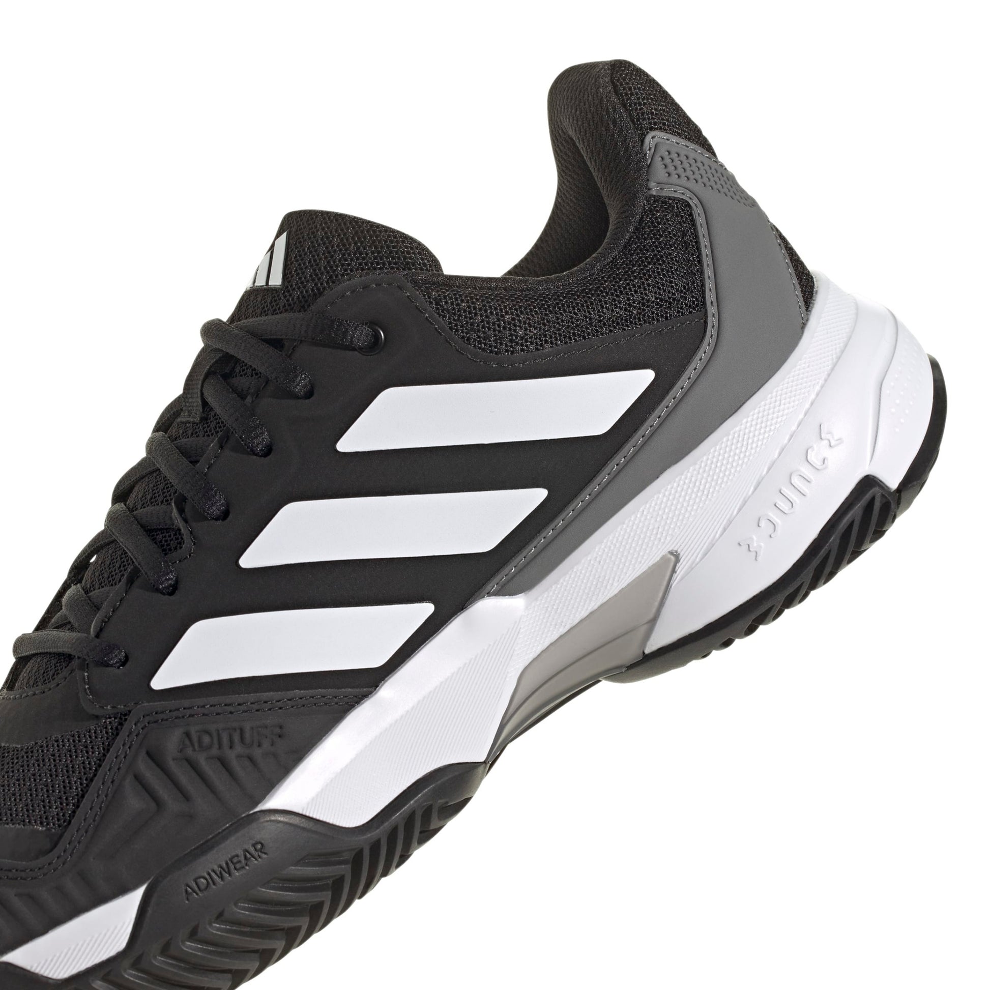 A black and white Adidas tennis shoe with three white stripes on the side, black laces, and a white and gray midsole, shown against a plain white background.