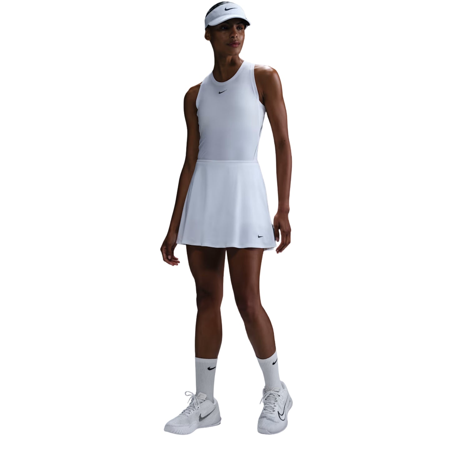 Woman wearing a white tennis outfit with Nike logo on a white background